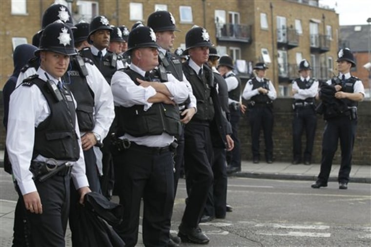 British police officers stand on duty during the children day of Notting Hill Carnival in London, Sunday, Aug. 28, 2011.  (AP Photo/Sang Tan)